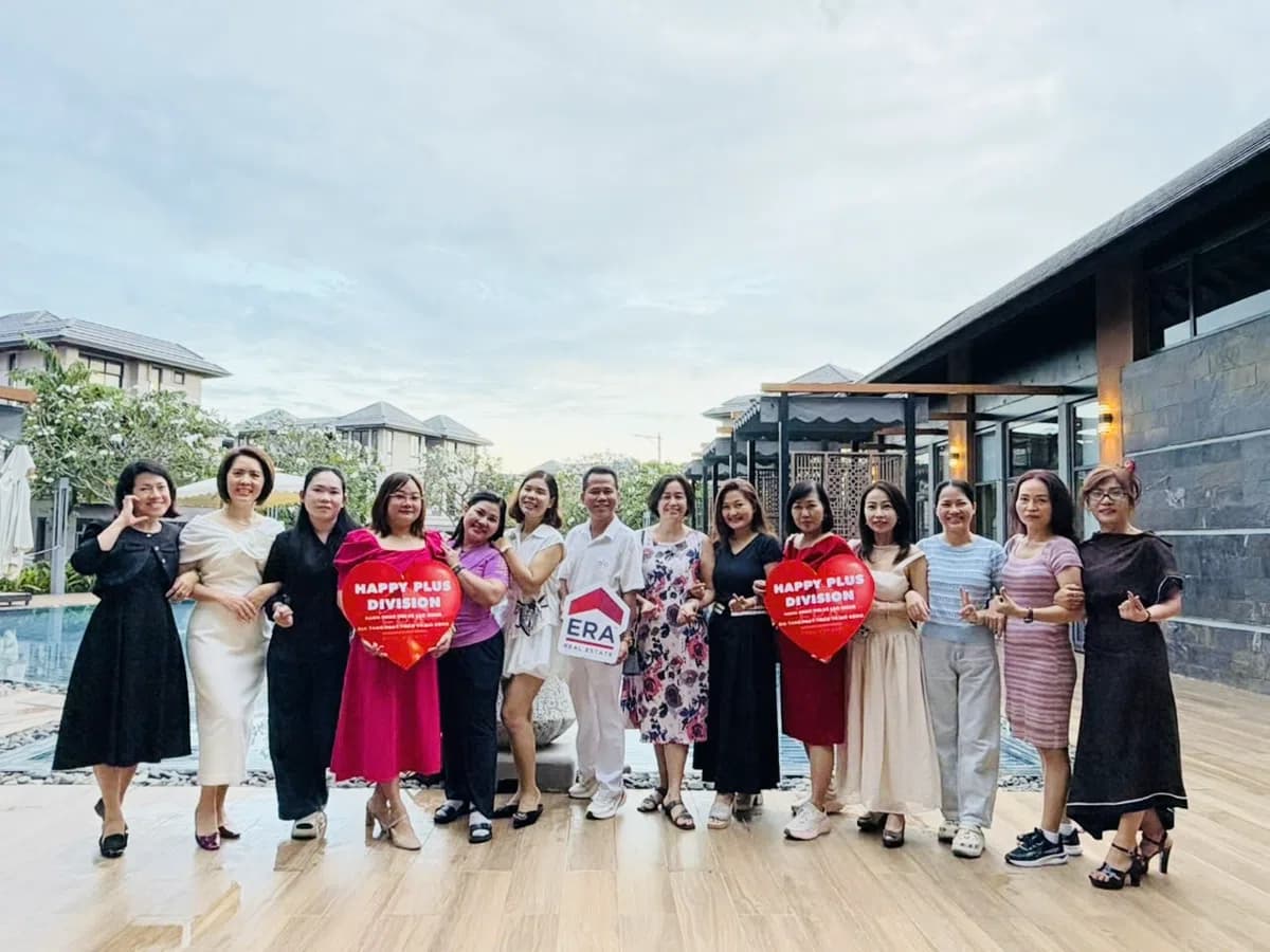 Team Happy Plus cầm biển trái tim Happy Plus Division và logo ERA trong tiệc 20/10